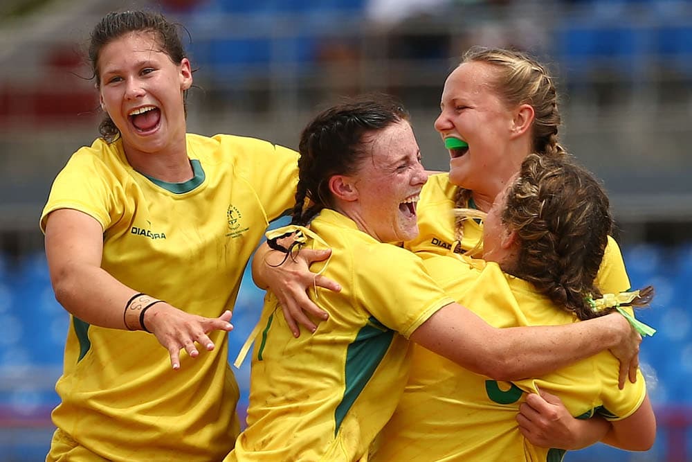Women celebrate winning gold at the Commonwealth Youth Games in 2015. Photo: Getty Images