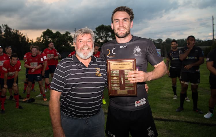 RA Volunteer 2 boys holding rugby trophy 